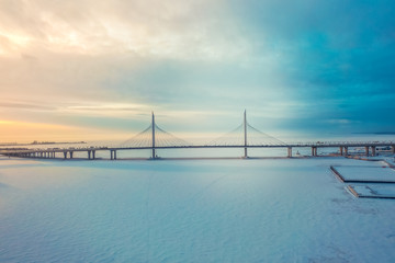 Bridge over the Neva River in winter sunset