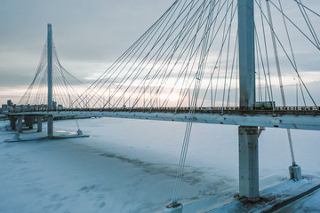 Fototapeta premium Bridge over the Neva River in winter sunset