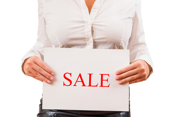 Fototapeta na wymiar Business woman in the blouse holding white paper with word sale. Concept. White background.