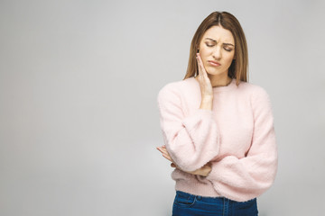 Beautiful young woman suffering from toothache on white background.