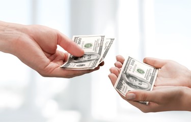 Two hands holding dollars banknote over  background