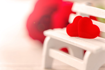 Concept of Valentine, anniversary, wedding celebration, heart shapes on a white wooden bench, bokeh background, close up