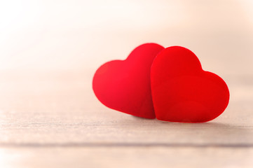 Fototapeta premium Concept of Valentine, anniversary, wedding celebration, heart shapes on a white wooden bench, bokeh background, close up