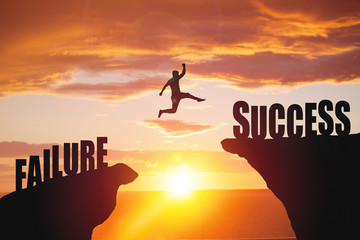 Silhouette of business man jump to success text