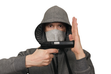 The man in a mask with a gun shows hands signs. White background