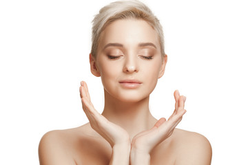 Obraz na płótnie Canvas The beautiful female face. The perfect and clean skin of face on white. The beauty, care, skin, treatment, health, spa, cosmetic concept