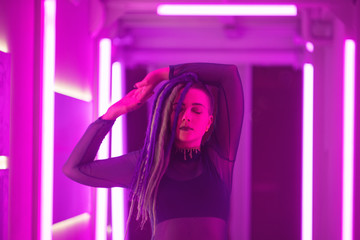 Neon pink girl with with green and purple dreadlocks
