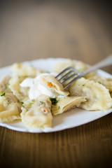 Dumplings boiled with stuffing on a wooden table