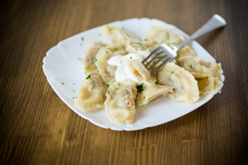 Dumplings boiled with stuffing on a wooden table