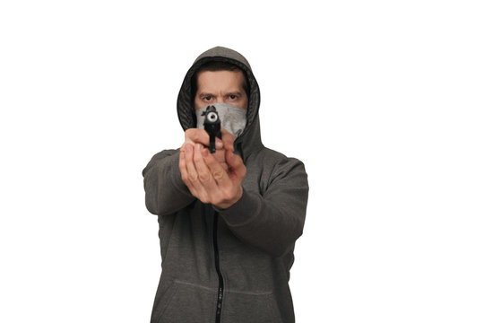 The man in a sports jacket and in a mask shoots with the gun