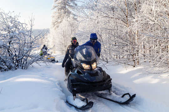Athletes on a snowmobile.
