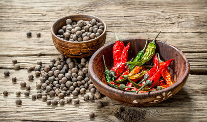 Hot peppers on wooden background.