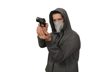 The man in a sports jacket and in a mask on a face shoots with the gun. White background