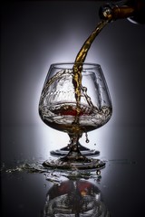 Fototapeta na wymiar pouring brandy into a glass