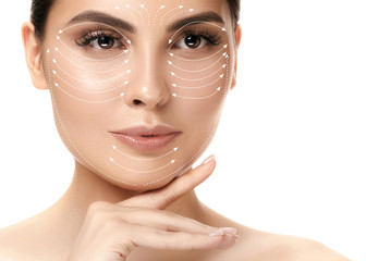 Close-up portrait of young, beautiful and healthy woman with arrows on her face. The spa, surgery,...