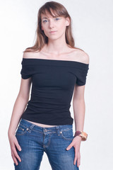 Beautiful young woman in black top and jeans. Fashion studio shoot on bright background. 