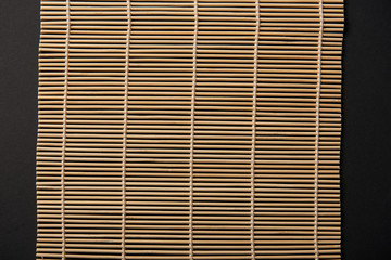 top view of bamboo table mat isolated on black