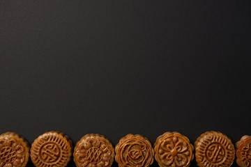 top view of traditional chinese mooncakes isolated on black with copy space