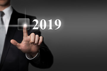 businessman presses virtual touchscreen interface button - 2019