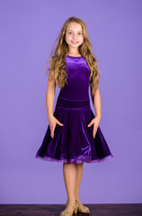 Kid fashionable dress looks adorable. Ballroom dancewear fashion concept. Kid dancer satisfied with concert outfit. Girl cute child wear velvet violet dress. Clothes for ballroom dance. Kids fashion