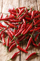 pile of fresh hot chili piri-piri pepper close-up on a table. vertical