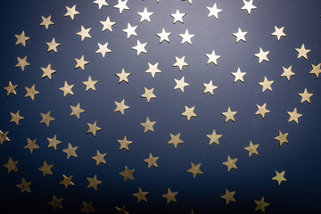 Golden stars isolated omn blue background.