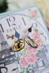 Wedding ring. Gold, vintage clock background