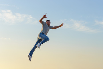 young man in a jump against a blue sky