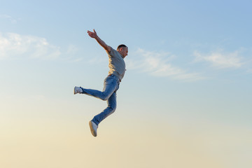 young man in a jump against a blue sky