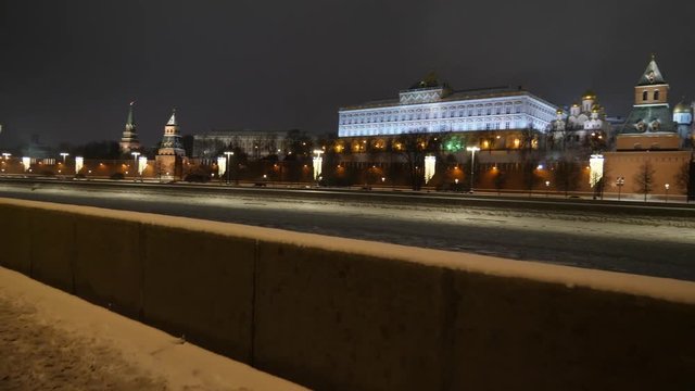 Kremlin embankment and Moscow River winter night view of Red Square Kremlin St. Basil's Cathedral and Spasskaya Tower gimbal shot