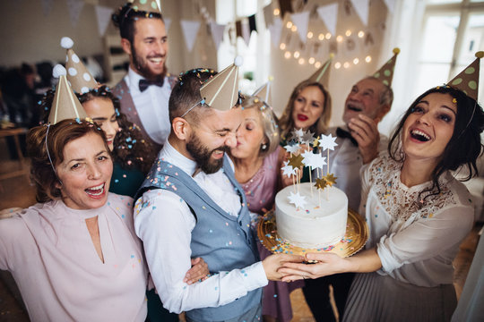 A Portrait Of Multigeneration Family With A Cake On A Indoor Birthday Party.