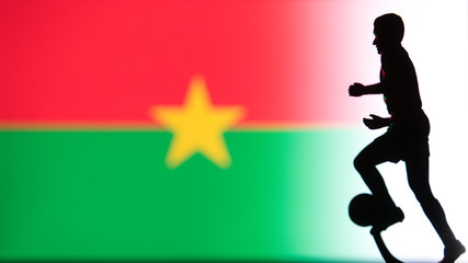 Fototapeta na wymiar Burkina Faso National Flag. Football, Soccer player Silhouette