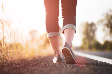 Closeup woman walking towards on the road side. Step concept.