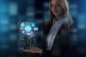 The concept of business, technology, the Internet and the network. A young entrepreneur working on a virtual screen of the future and sees the inscription: STEM