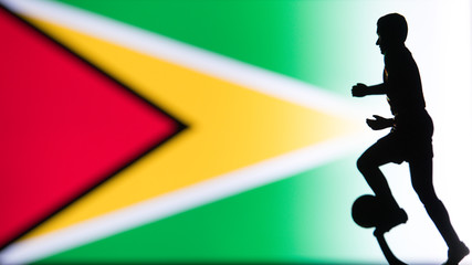 Fototapeta na wymiar Guyana National Flag. Football, Soccer player Silhouette