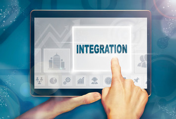 A hand selecting a Integration business concept on a computer tablet screen with a colorful background.