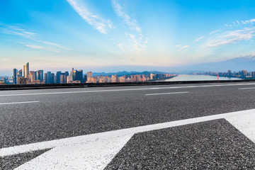 Fototapeta na wymiar Empty asphalt road and city skyline at sunrise in hangzhou,high angle view