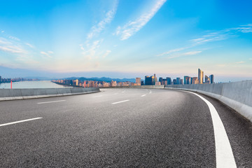 Empty asphalt road and city skyline at sunrise in hangzhou,high angle view