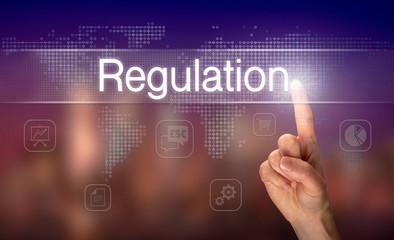A hand selecting a Regulation business concept on a clear screen with a colorful blurred background.