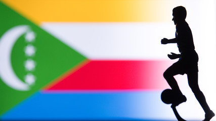 Fototapeta na wymiar Comoros National Flag. Football, Soccer player Silhouette