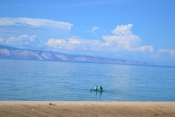  Lake on the background of mountains. People in the boat.