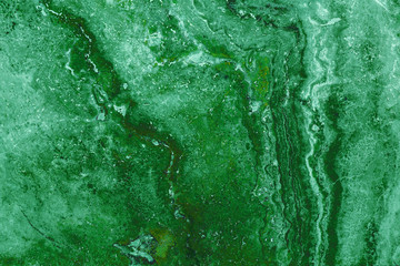 the texture of artificial marble green emerald color with a beautiful pattern similar to the mineral malachite.