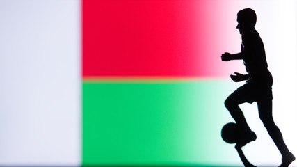 Fototapeta na wymiar Madagascar National Flag. Football, Soccer player Silhouette