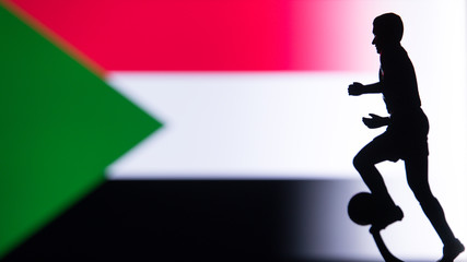Fototapeta na wymiar Sudan National Flag. Football, Soccer player Silhouette