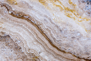 the texture of artificial marble is light natural beige with a beautiful pattern and dark inclusions.