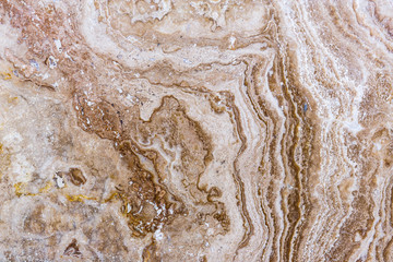 the texture of artificial marble is light natural beige with a beautiful pattern and dark inclusions.