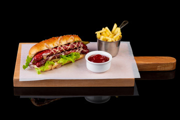 hotdog with fries on a black background