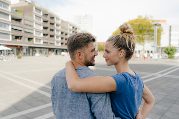 Netherlands, Maastricht, rear view of happy young couple in the city