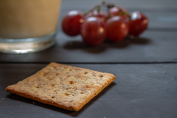 Breakfast with wholemeal cookies, fruits and drink on a rustic background.