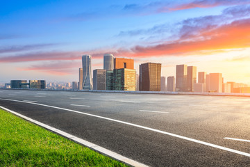Fototapeta premium Empty asphalt road and city skyline in Hangzhou at sunrise,high angle view